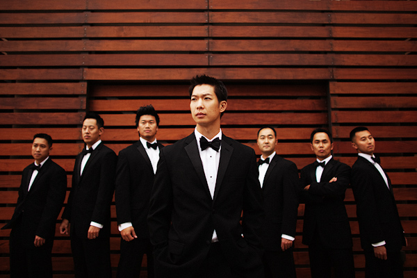photo by Dallas wedding photographers Poser Image - groom with groomsmen in black tuxedos and bow ties 